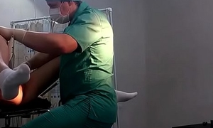 A girl in lacklustre socks on a gynecological chair